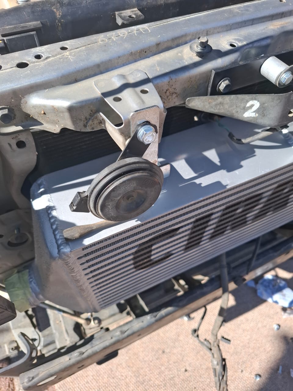 Upgraded front-mount intercooler installed behind the front end