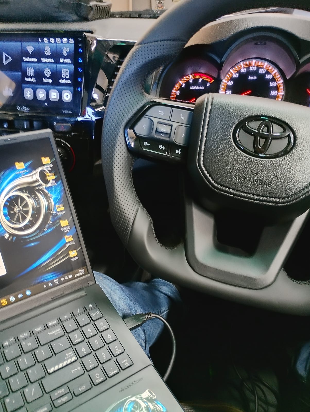 Mobile ECU remapping session inside a Toyota Hilux